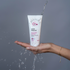 Eine OMNi-BiOTiC SKiN Intensiv-Pflegesalbe unter einem Wasserstrahl